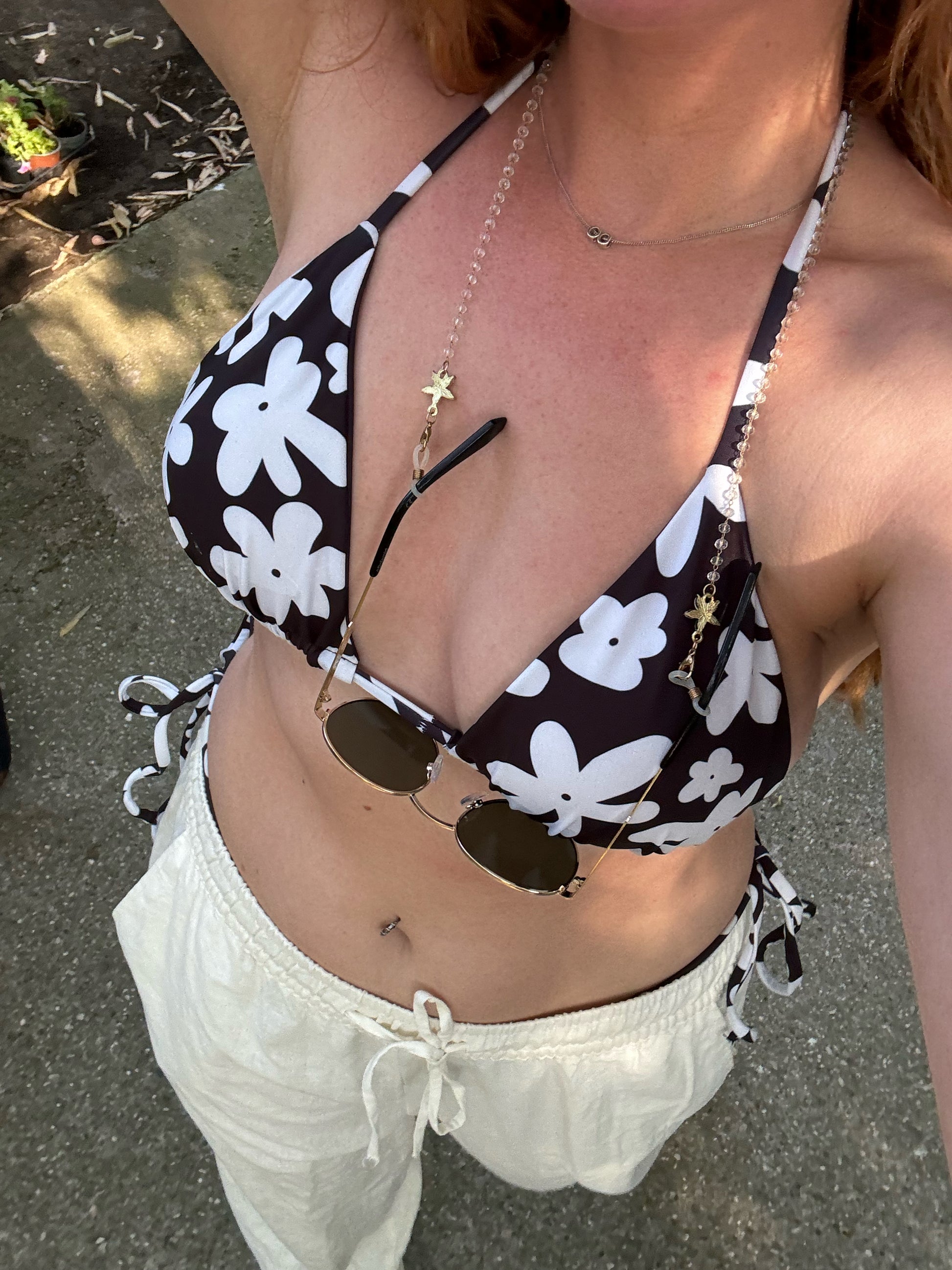A stylish and comfortable bikini set called the Midnight Flower Bikini Set, made from high-quality, soft, and stretchy recycled material with UPF 50+ sun protection. This eco-friendly bikini set is perfect for swimming, sunbathing, or poolside lounging. I