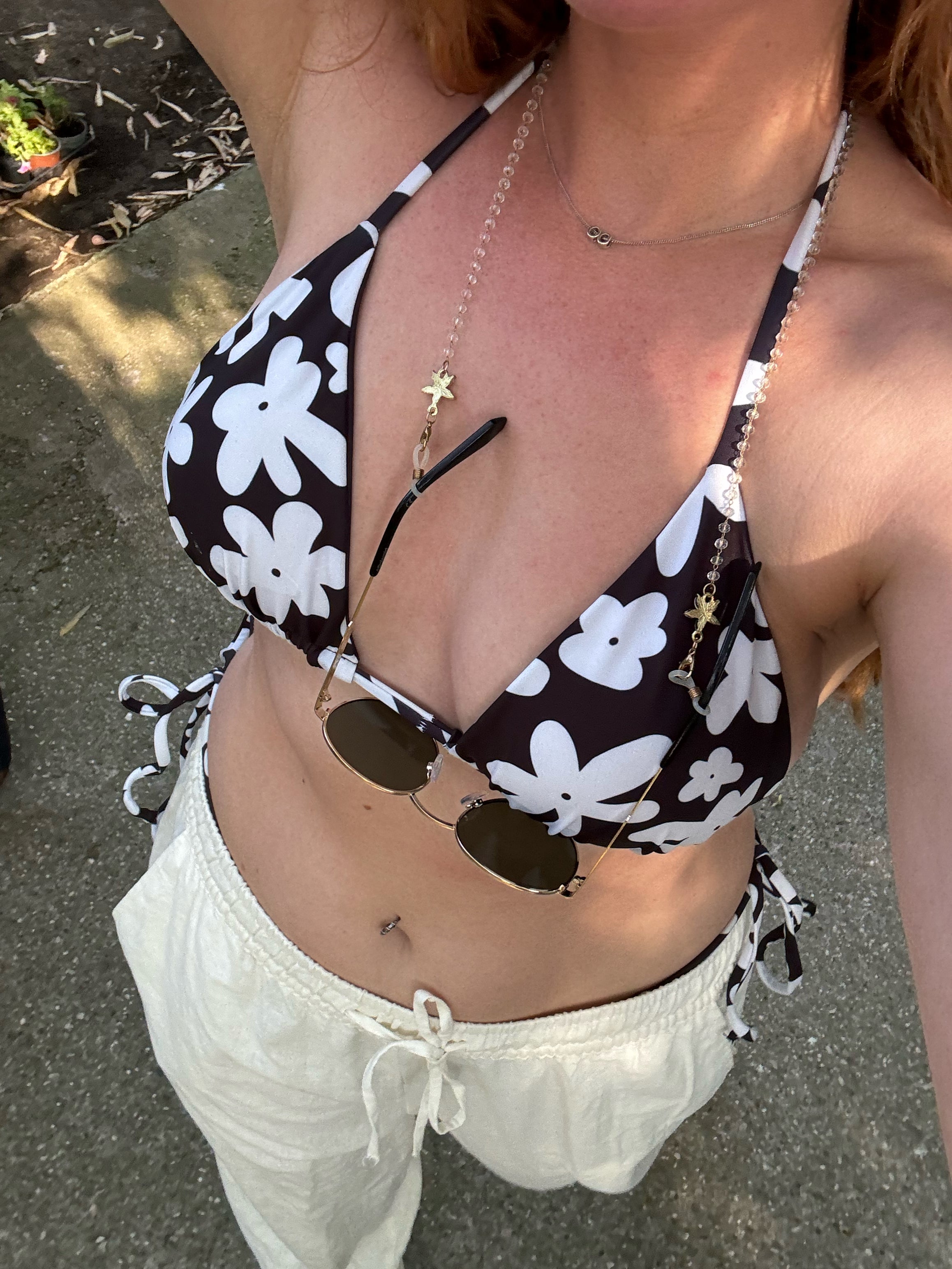 A stylish and comfortable bikini set called the Midnight Flower Bikini Set, made from high-quality, soft, and stretchy recycled material with UPF 50+ sun protection. This eco-friendly bikini set is perfect for swimming, sunbathing, or poolside lounging. I