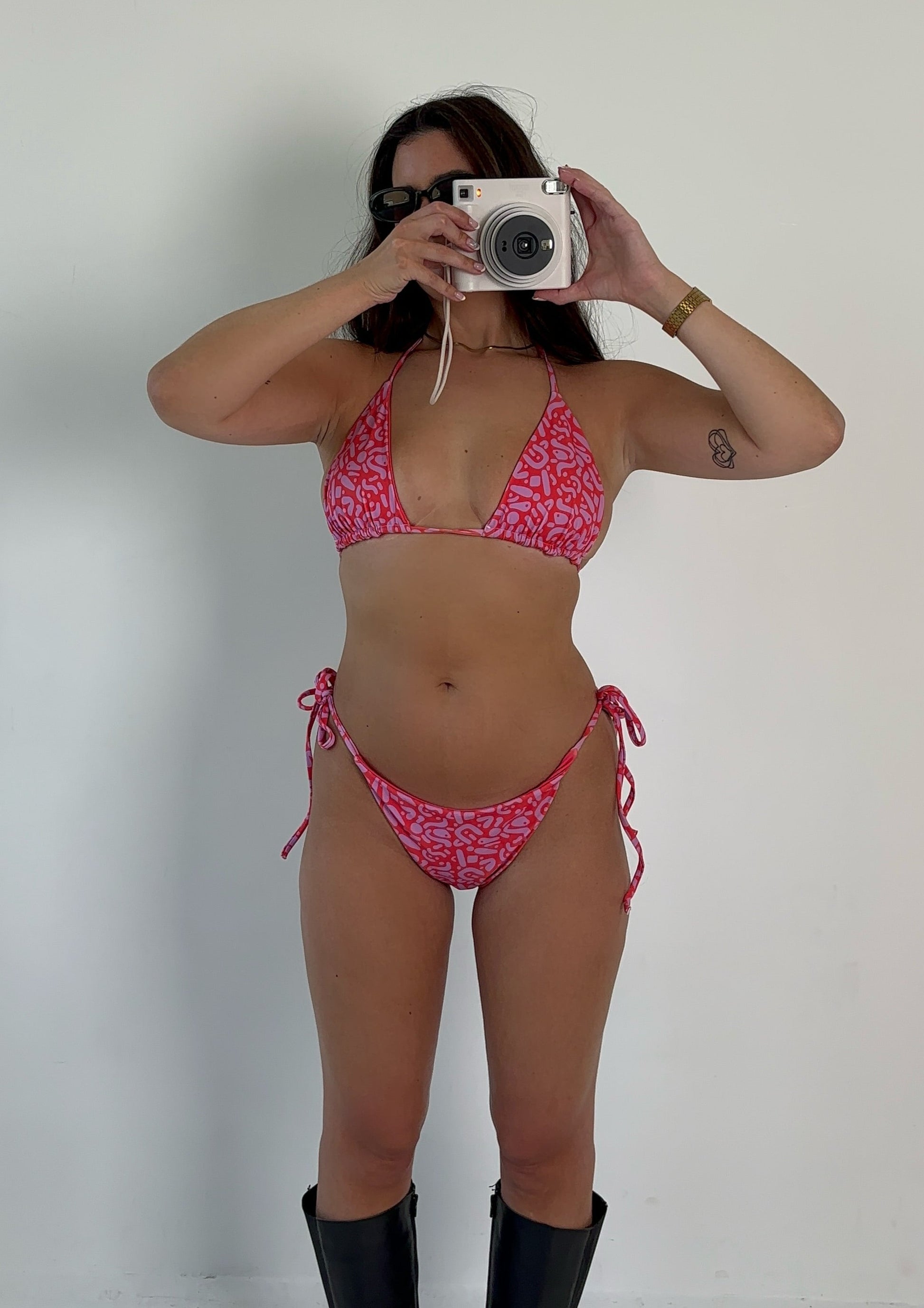 Sustainable Ruby Reef Bikini Set top in red and pink geometric pattern made with recycled plastic. Available in a range of sizes from 2XS to 6XL. Long lasting bikini, multiple ways to wear and buttery soft fabric. Made to order, just for you