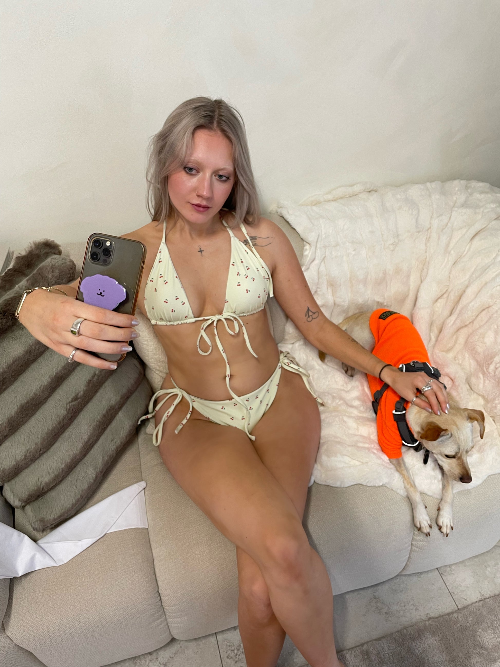A yellow bikini set called the Cherry Orchard Bikini Set, made from high-quality, soft, and stretchy material with UPF 50+ sun protection. This eco-friendly bikini set is perfect for swimming, sunbathing, or poolside lounging. It comes in a wide range of