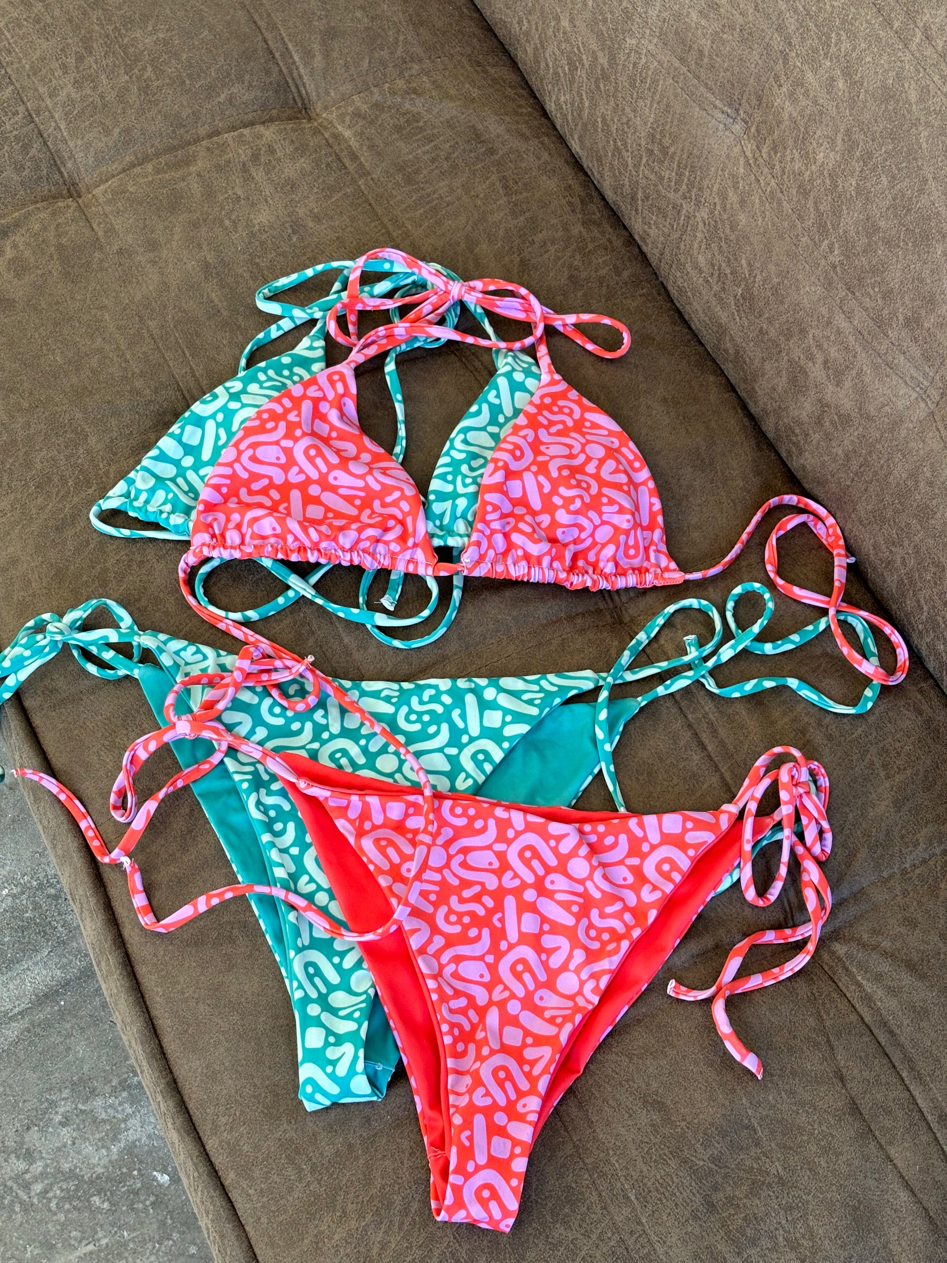 Sustainable Ruby Reef Bikini Set top in red and pink geometric pattern made with recycled plastic. Available in a range of sizes from 2XS to 6XL. Long lasting bikini, multiple ways to wear and buttery soft fabric. Made to order, just for you