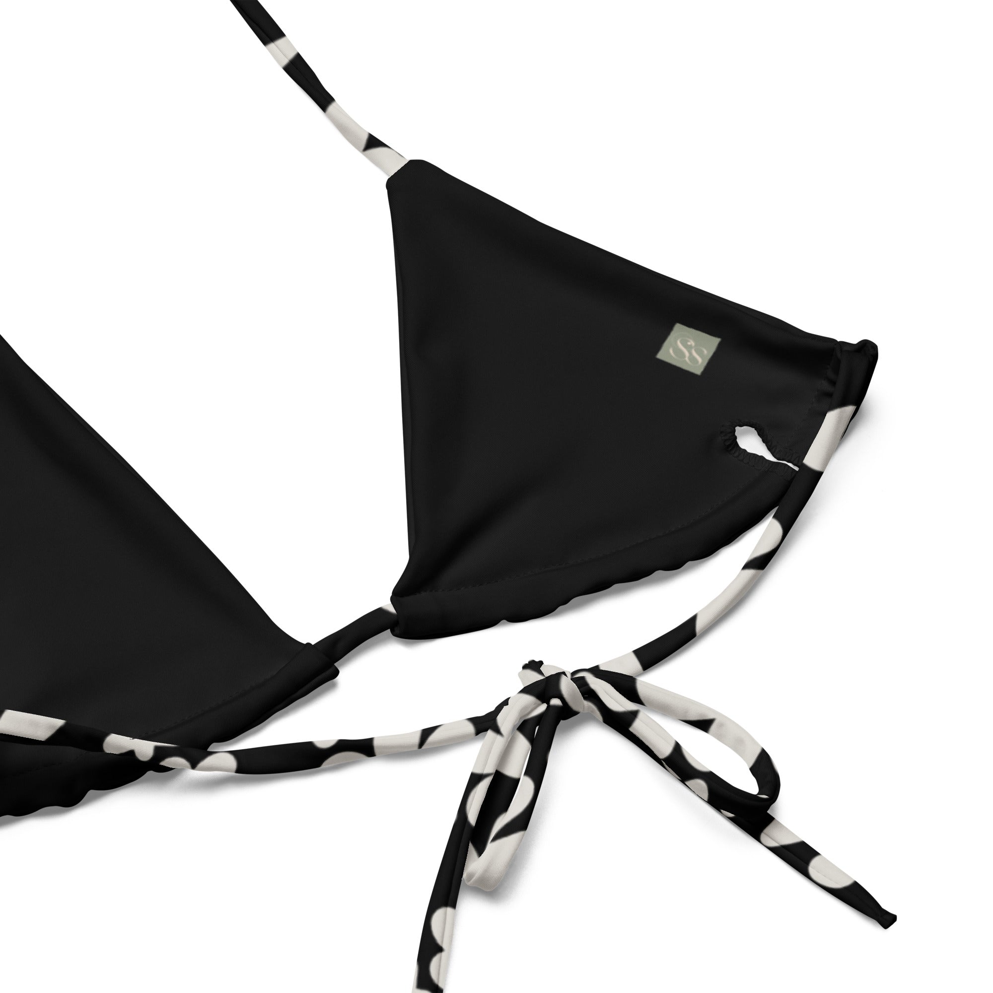 A stylish and comfortable bikini top called the Midnight Flower Bikini Top, made from recycled polyester with UPF 50+ sun protection. This flattering top features a black and white floral print and comes in a wide range of sizes, from XS to 6XL, to ensure